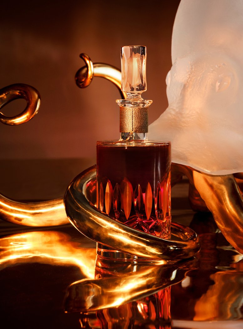 Camus Cognac still life — crystal, amber, copper